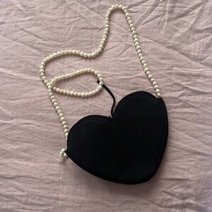 DONNI. Black Accessory with Cream Label